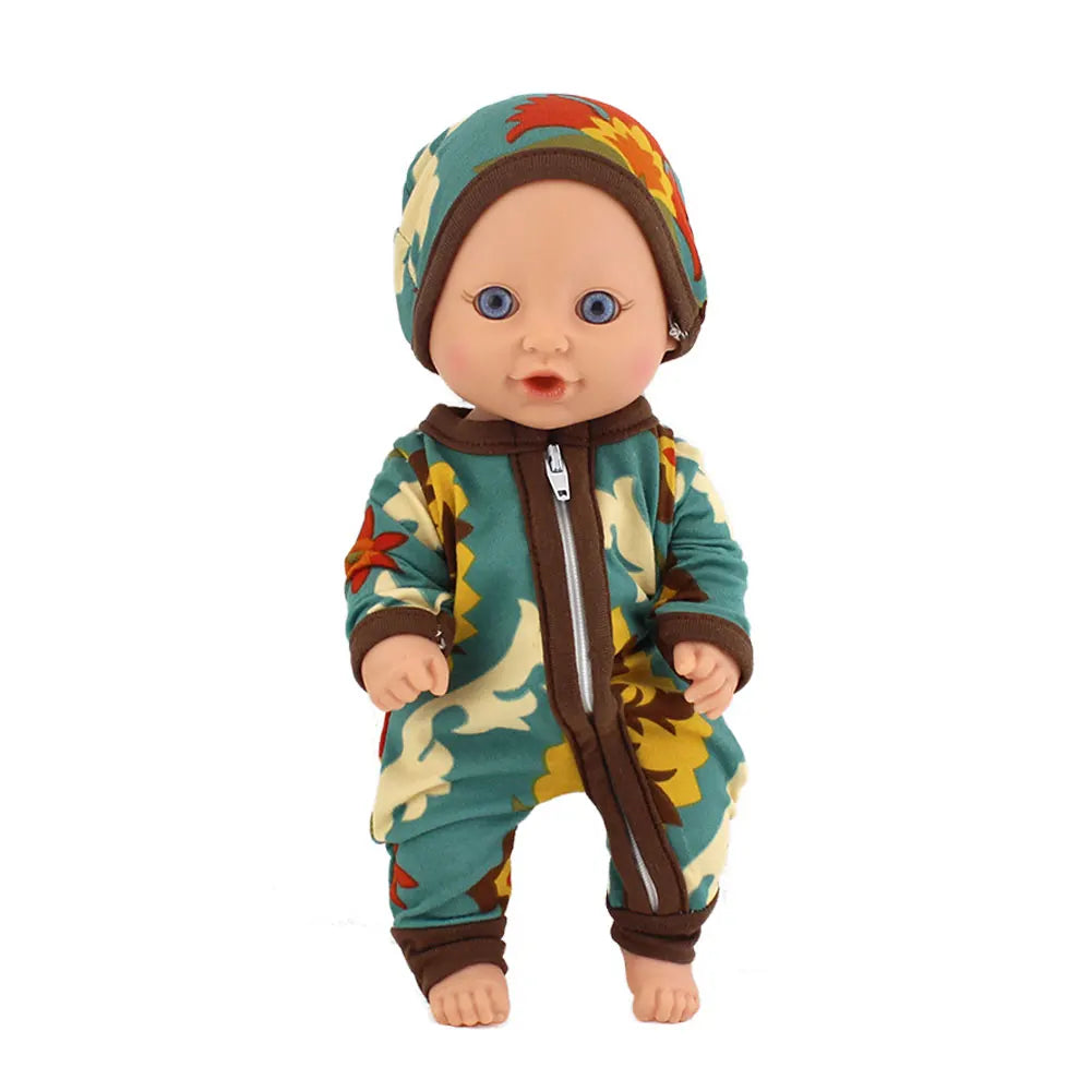 A baby doll wearing a green and brown floral jumpsuit outfit.