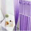 Purple beaded thread curtain hanging in a doorway, showing vertical strands of purple threads.
