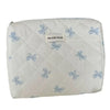 A white quilted cosmetic bag with light blue bow print and a small label reading the jolly house.