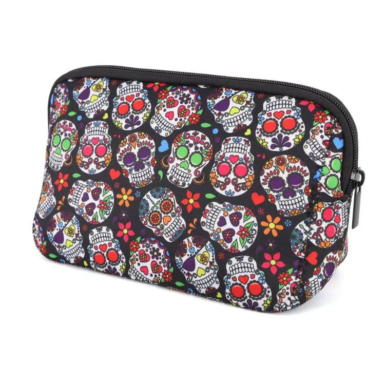 A black cosmetic bag featuring a pattern of colorful skulls and flowers with a zipper closure.