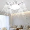 A modern white LED ceiling fan with multiple light heads illuminates a living room ceiling.