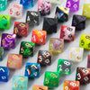 A collection of ten polyhedral dice in various colors and finishes, including pink, black, green, and purple.