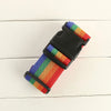 Adjustable polyester luggage strap featuring a rainbow color pattern on a black strap.