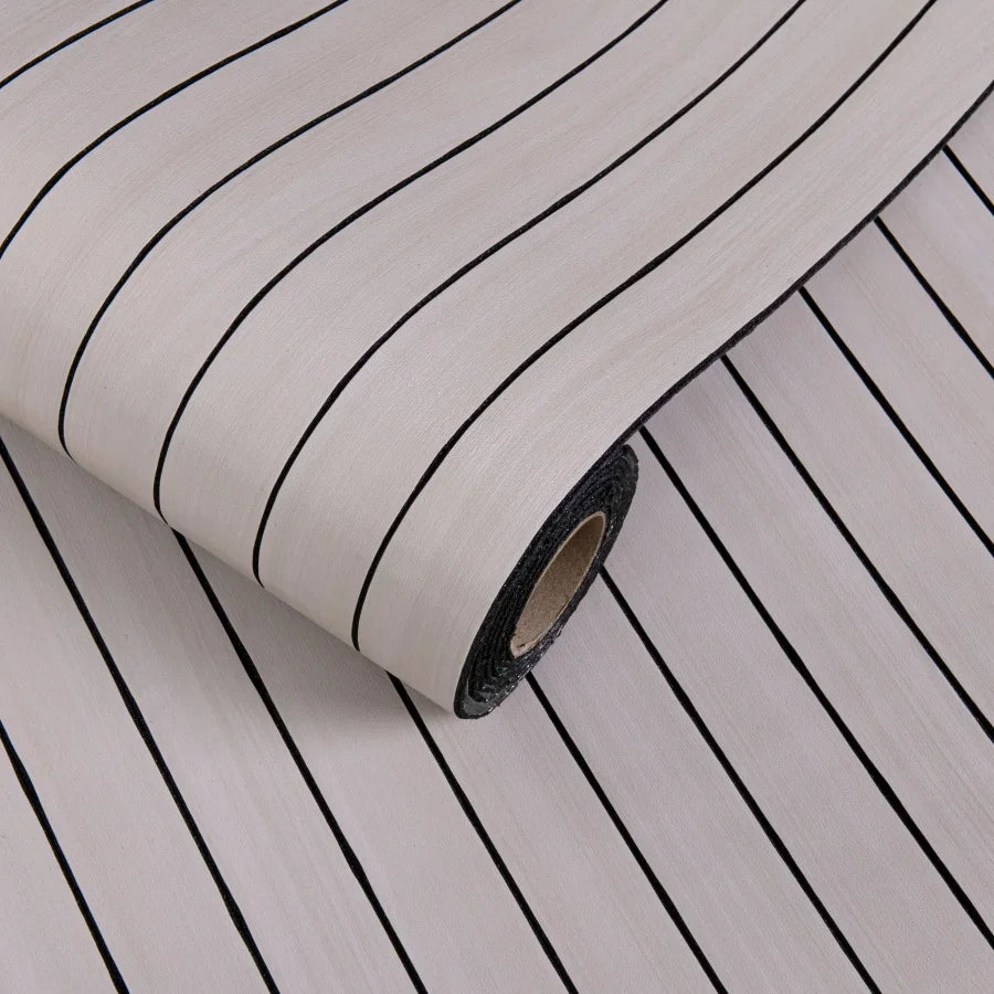 Roll of 3D grille pattern peel-and-stick wallpaper showing vertical black and white stripes.