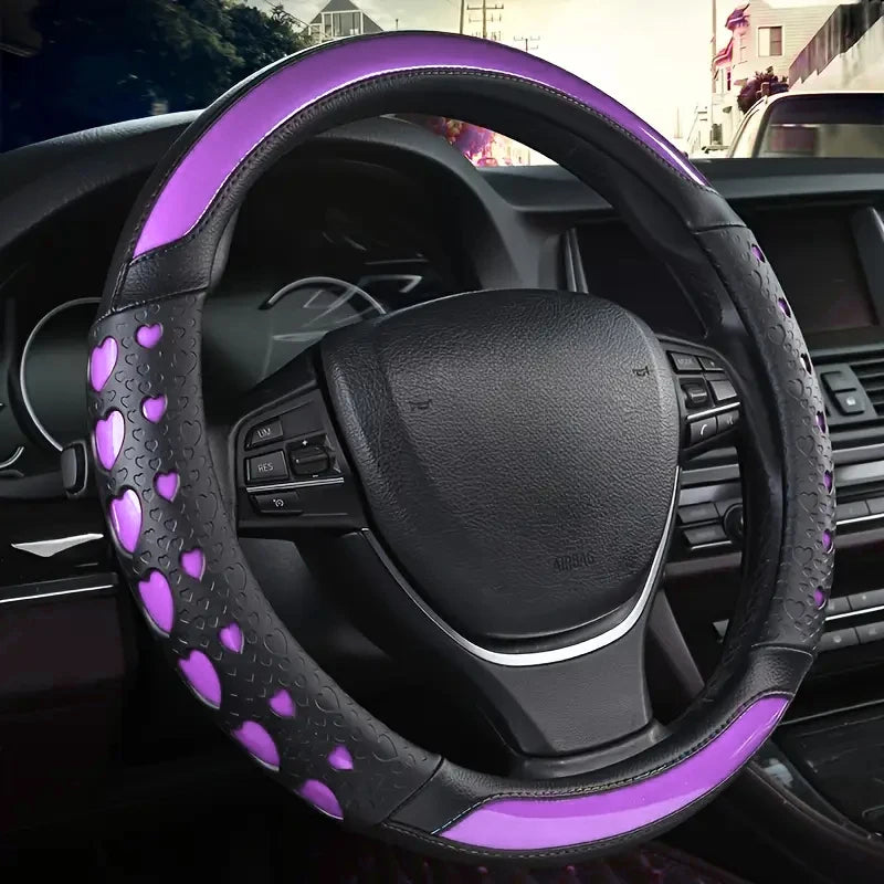 A purple heart-shaped steering wheel cover in soft PU leather installed in a car interior.