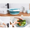 A blue wash basin is shown in a kitchen setting, next to a sink and wooden counter.