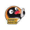 A black and orange cartoon penguin enamel pin with a yellow banner that reads SEND NOOTS