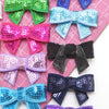 A collection of five sparkly sequin bow patches in various colors including green pink purple blue and black