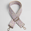 A beige and purple paisley jacquard bag strap with gold hardware.
