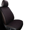 A close-up view of a black car seat cover featuring a quilted pattern with red stitching.