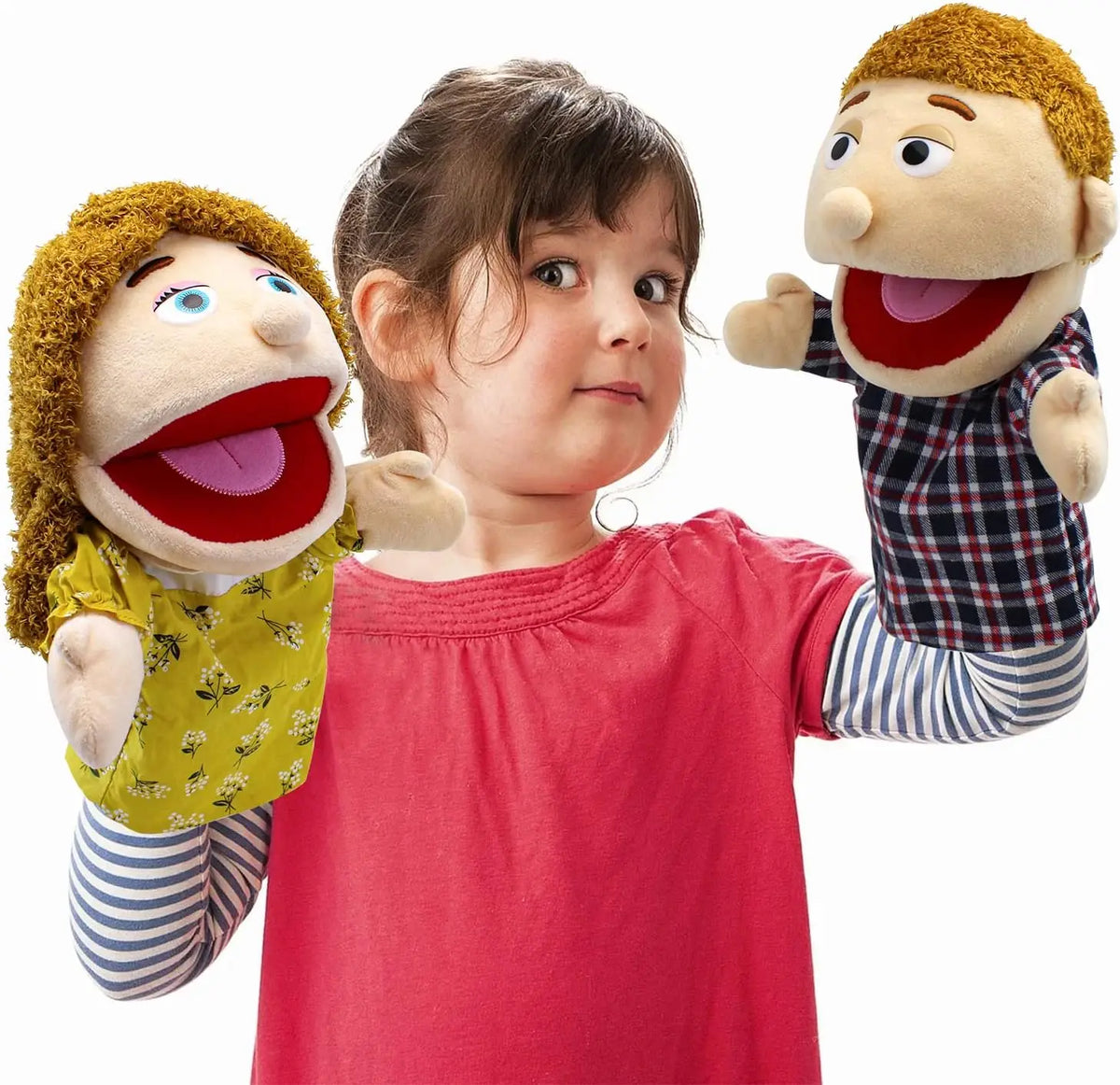 A young girl is holding two soft hand puppets, one resembling a man and one resembling a woman.