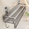 A stainless steel wall-mounted shower caddy with suction cups is shown against a light wall.