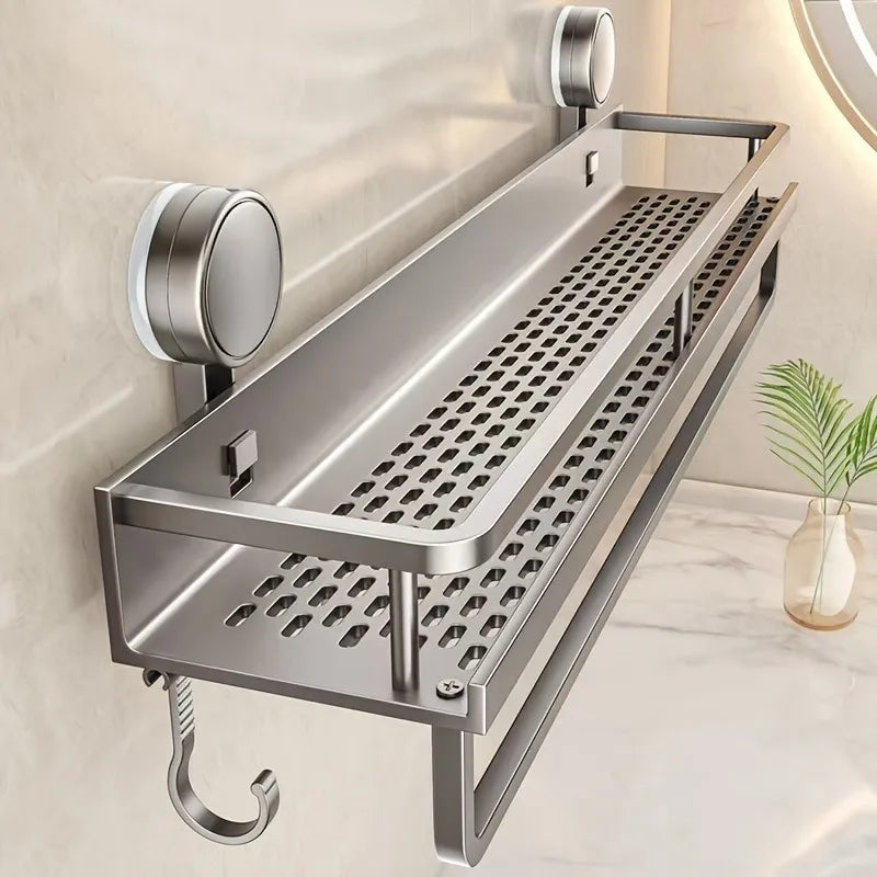A stainless steel wall-mounted shower caddy with suction cups is shown against a light wall.