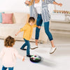 A woman is playing soccer with a young boy using an LED hover soccer ball.