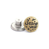 A round brass button with the text Jeans Wear and a silver button repair kit component.