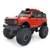 Red RC truck with rubber mud terrain tires and black accents.