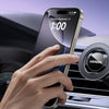 A hand uses a magnetic car phone mount to operate a smartphone displaying the time on a dashboard.