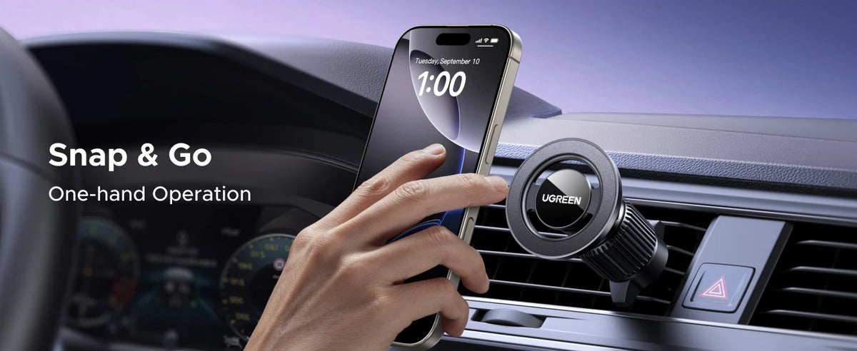 A hand uses a magnetic car phone mount to operate a smartphone displaying the time on a dashboard.