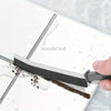 A black crevice cleaning brush is shown being used to clean a white surface, with water droplets visible.