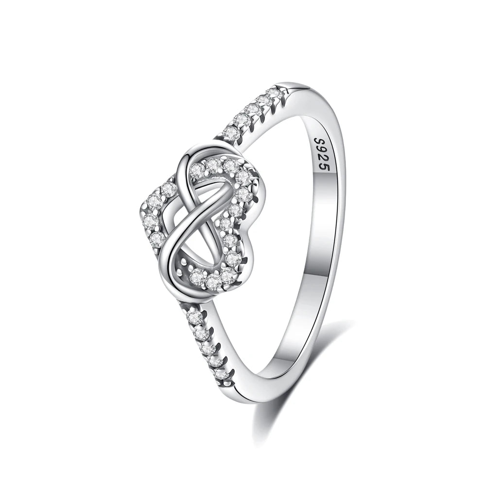 A sterling silver heart-shaped ring adorned with pave cubic zirconia stones.