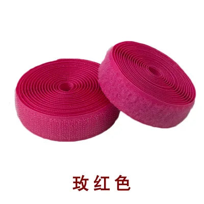 A roll of bright pink sew-on hook and loop tape with a textured surface.