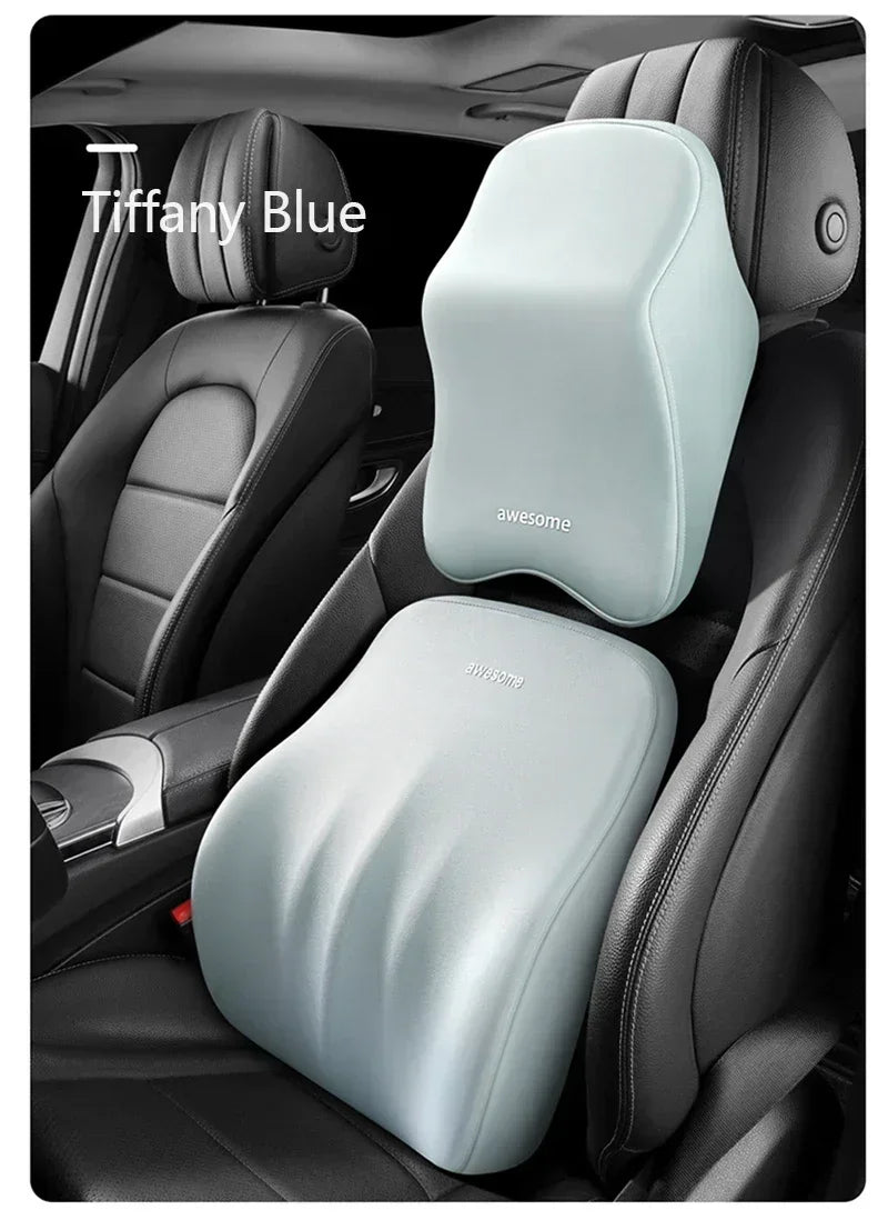 A light blue memory foam car headrest pillow with shoulder support placed on a black car seat.