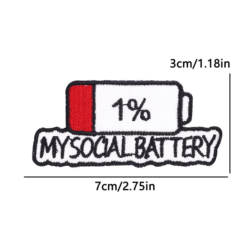 An embroidered iron-on patch showing a white cylindrical battery with a red cap and the text 1% and MYSOCIAL BATTERY.