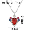A silver pendant necklace featuring a red stone and blue accents, measuring 3.5cm long.
