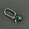 A silver D-shaped buckle keychain charm featuring a green dice with the number 13.