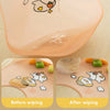 A soft silicone baby bib with a cute cartoon animal print showing before and after wiping.