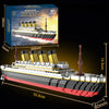 A scale model of the Titanic ship built from interlocking plastic blocks, shown in a side view.