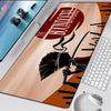 A large gaming mouse pad featuring a graphic of a character and text from The Boondocks