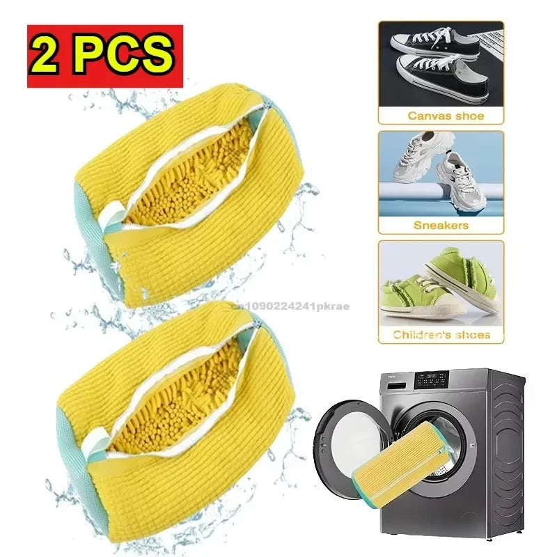 Two yellow reusable shoe laundry bags with bristled brushes shown next to a washing machine.