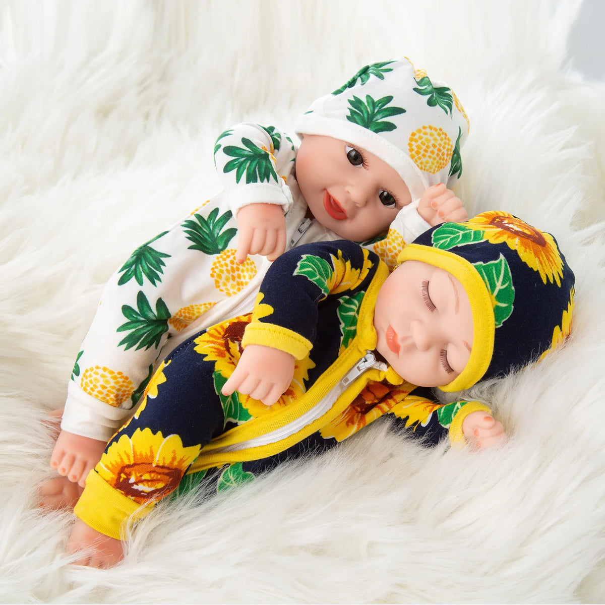 A baby doll wearing a yellow and green floral jumpsuit outfit, lying on white fluffy fur.