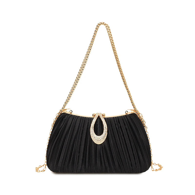 Black pleated evening clutch with a gold rhinestone loop and a gold chain strap