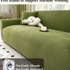 A green stretch jacquard sofa cover is displayed on a sofa, with a washing machine visible in the foreground.