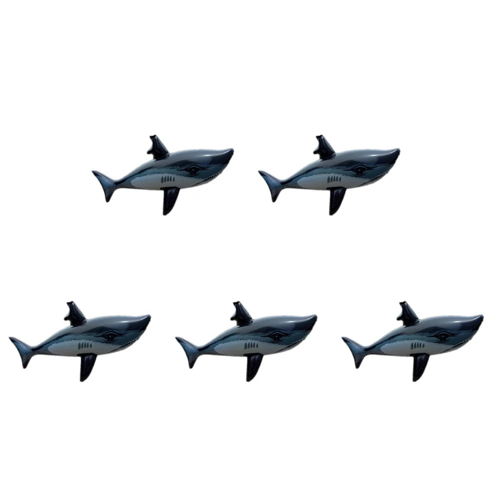 A set of three inflatable shark pool floats in shades of gray and black.
