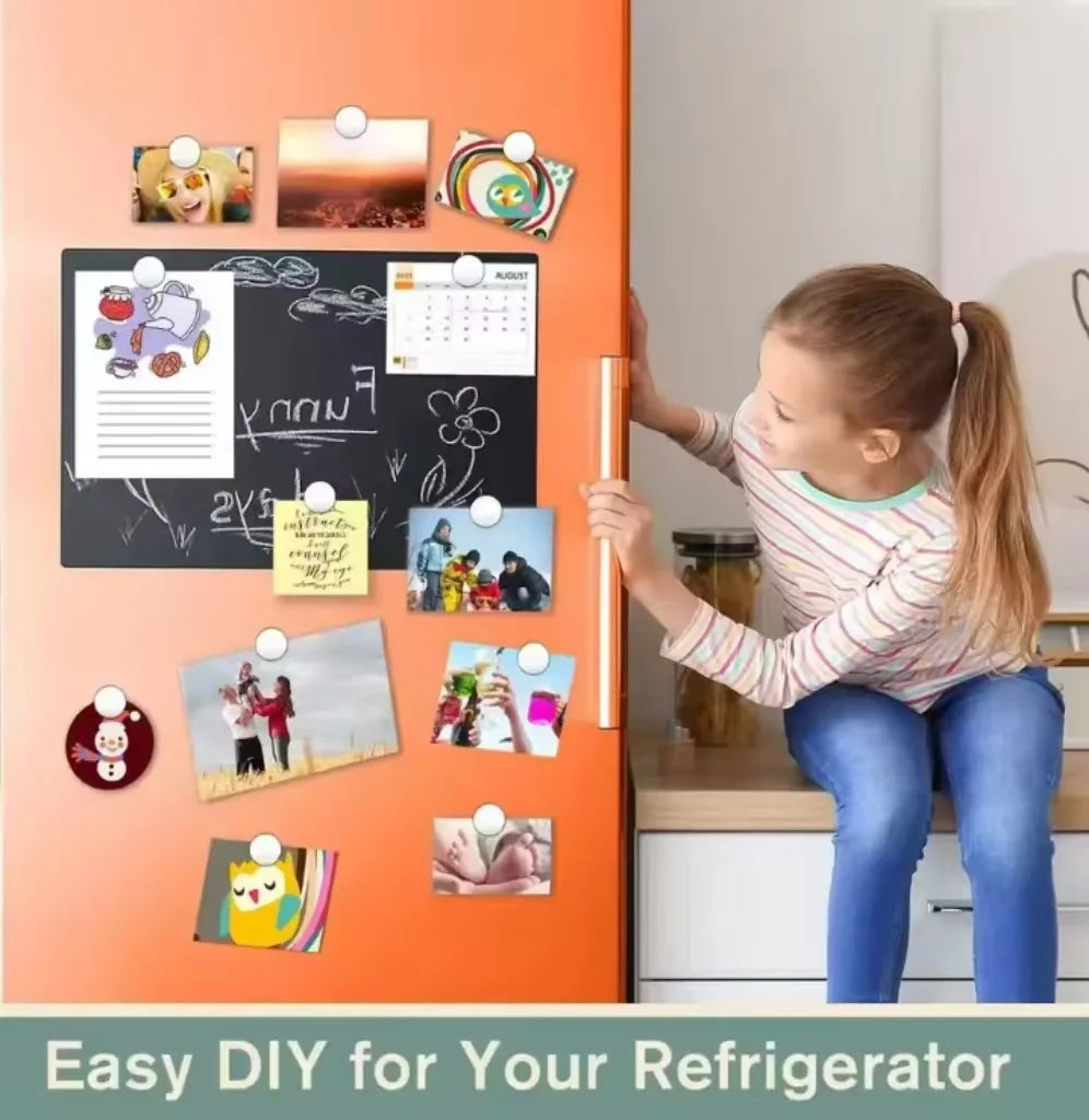A girl is placing round magnets onto an orange refrigerator door for a DIY decoration project.