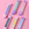 Six colorful poking pens in various shades of pink and purple arranged diagonally on a pink background.