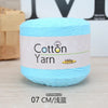 A ball of light blue cotton yarn labeled as Cotton Yarn 100g for knitting and crochet.