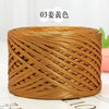 A ball of metallic gold flat ribbon yarn for crochet and knitting