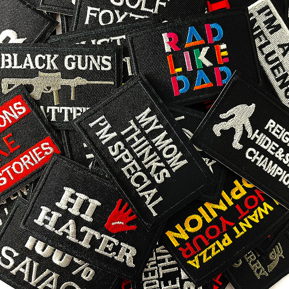 A collection of black embroidered iron-on patches featuring text like RAD LIKE DAD, I'M HATER, and other funny sayings.