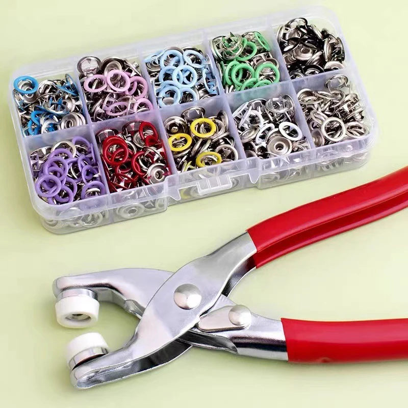 A clear plastic container holds a 50-piece snap fastener kit with hand press pliers.