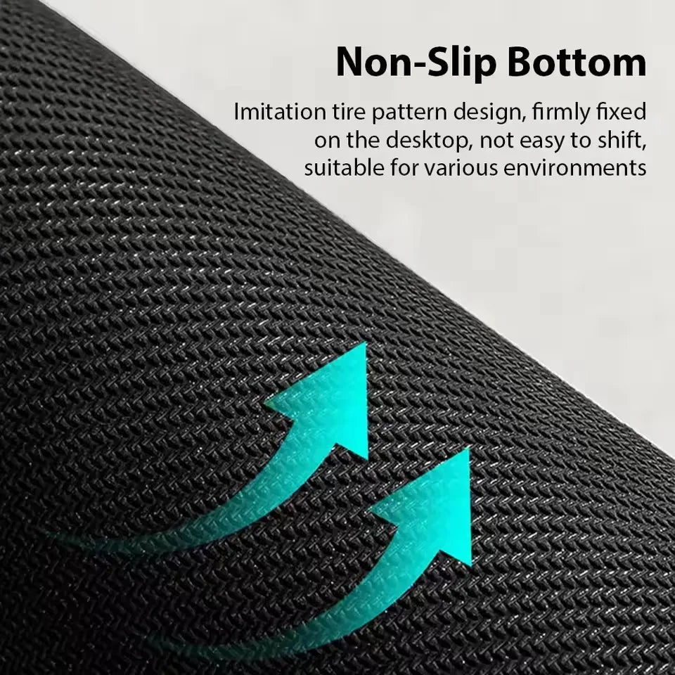 Close-up view of a black non-slip mouse pad with a textured surface and bright teal arrows indicating grip.