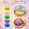 A variety of colorful glitter squishy fidget toys are displayed in an open yellow container.