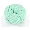 A ball of light mint green chunky chenille yarn used for knitting and crochet