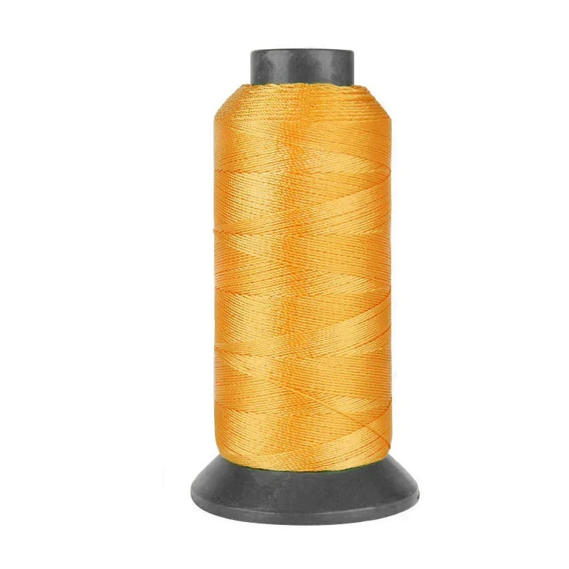A spool of heavy-duty orange nylon sewing thread for upholstery and denim.