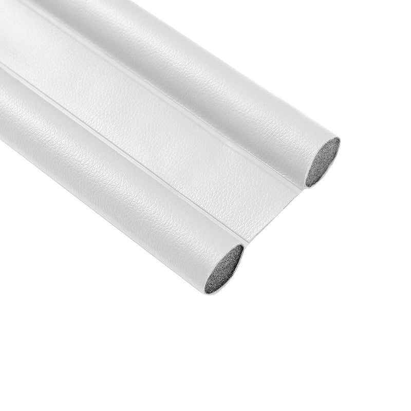 A roll of white flexible door bottom sealing strip used for weatherproofing and draft guarding.