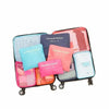A set of six colorful laundry pouches and packing cubes for travel organization.