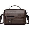 A dark brown faux leather crossbody bag with a top handle and adjustable strap.